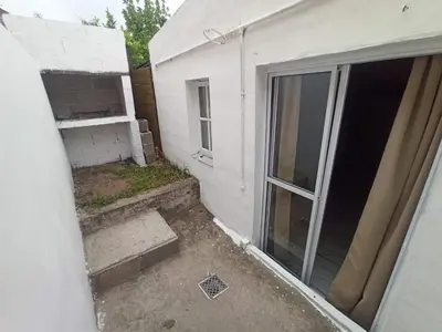 a view of the outside of a house with a sliding glass door at Complejo EL ALTO in Tanti