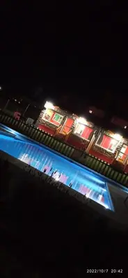 a view of a building with lights at night at Cabañas Potrero de Garay in La Estancia