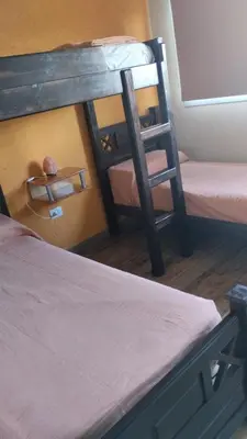 a room with two bunk beds and a ladder at Cabañas Potrero de Garay in La Estancia