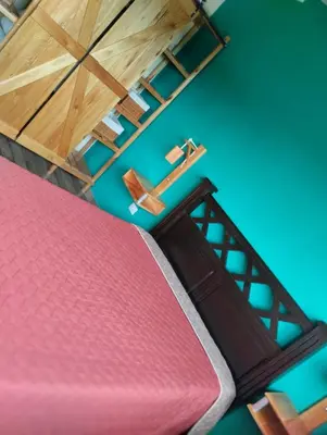 a room with a ladder and a red mattress at Cabañas Potrero de Garay in La Estancia