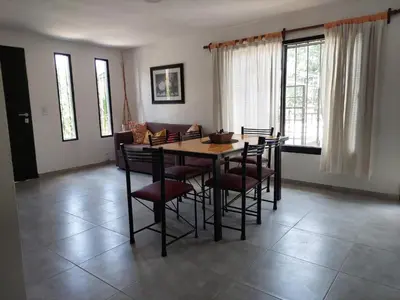 a dining room with a wooden table and chairs at EnlodelLuly in Villa Carlos Paz