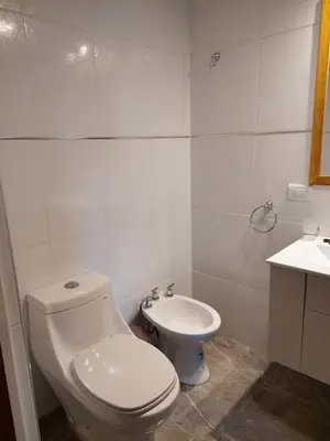 a bathroom with a toilet and a sink at EnlodelLuly in Villa Carlos Paz