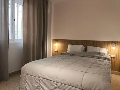 a bedroom with a large bed and a window at Refugio en el centro in Cordoba
