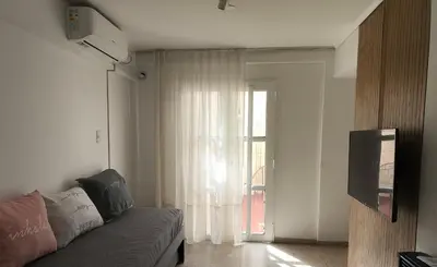 a living room with a couch and a window at Refugio en el centro in Cordoba