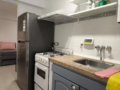 a small kitchen with a stove and a sink at Refugio en el centro in Cordoba