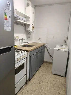 a small kitchen with a stove and a sink at Refugio en el centro in Cordoba