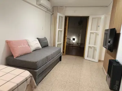 a living room with a couch and a tv at Refugio en el centro in Cordoba