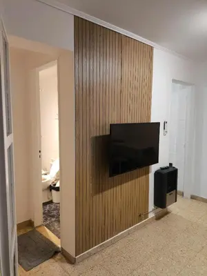 a room with a television on a wooden wall at Refugio en el centro in Cordoba