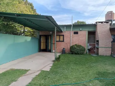 a house with awning on the side of it at Duplex la casita de papá in Mina Clavero