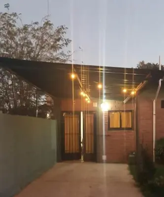 a house with lights on the front of it at Duplex la casita de papá in Mina Clavero