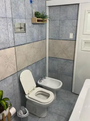 a bathroom with a toilet and a sink at Departamento Centro Córdoba con Cochera Privada in Cordoba
