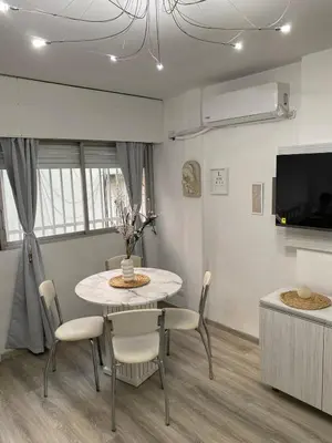 a dining room with a table and chairs and a tv at Departamento Centro Córdoba con Cochera Privada in Cordoba