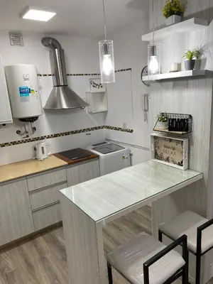 a kitchen with a table and chairs in it at Departamento Centro Córdoba con Cochera Privada in Cordoba