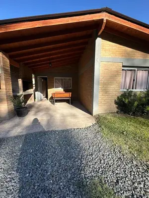 a patio of a house with a bench under it at Cabañas Torres in Mina Clavero