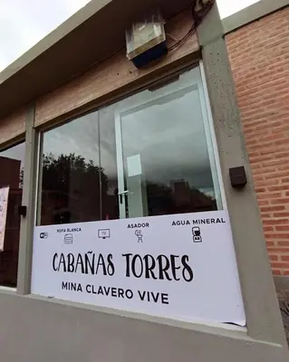 a sign on a window of a building at Cabañas Torres in Mina Clavero