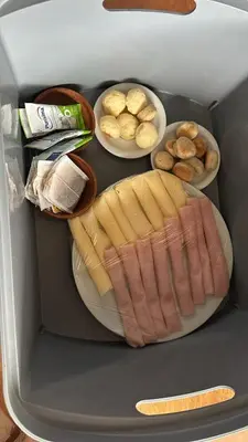a refrigerator with a hot dog and other foods at Cabañas Torres in Mina Clavero