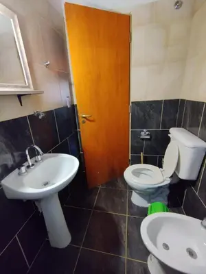 a bathroom with a toilet and a sink at Cabañas Torres in Mina Clavero
