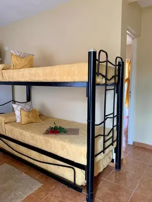 a couple of bunk beds in a room at Complejo sierras de brochero in La Porteña