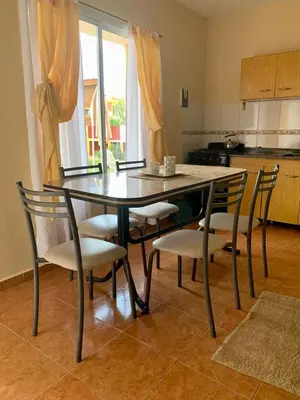a dining room table and chairs in a kitchen at Complejo sierras de brochero in La Porteña