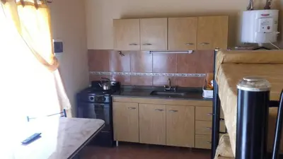 a small kitchen with a sink and a stove at Complejo sierras de brochero in La Porteña