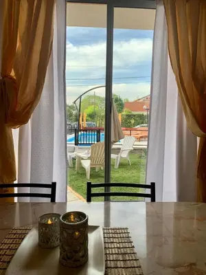 a table with two candles and a view of a patio at Complejo sierras de brochero in La Porteña