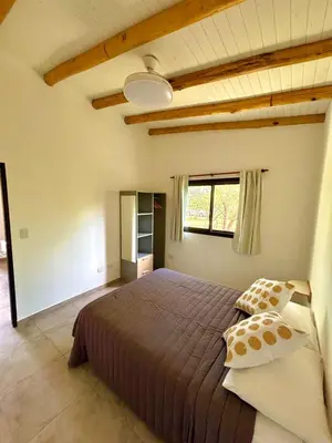 a bedroom with a large bed and a window at La Corrida hospedaje in San Javier