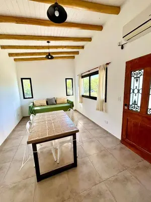 a living room with a table and a couch at La Corrida hospedaje in San Javier
