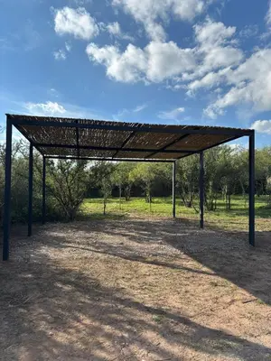 a metal structure sitting on top of a field at La Corrida hospedaje in San Javier