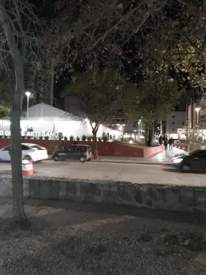 a group of cars parked in a parking lot at night at Departamento en Carlos Paz, céntrico in Villa Carlos Paz