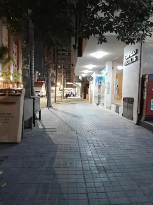 an empty sidewalk in a city at night at Departamento en Carlos Paz, céntrico in Villa Carlos Paz