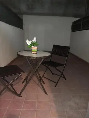 a table and two chairs in a room at Departamento en Carlos Paz, céntrico in Villa Carlos Paz