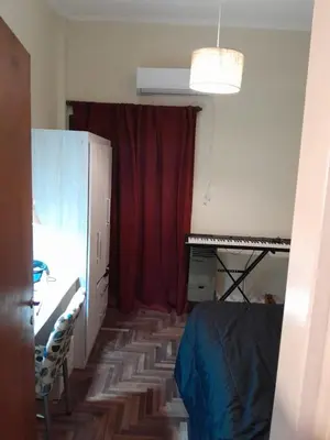a bedroom with a bed and a red curtain at Departamento en Carlos Paz, céntrico in Villa Carlos Paz