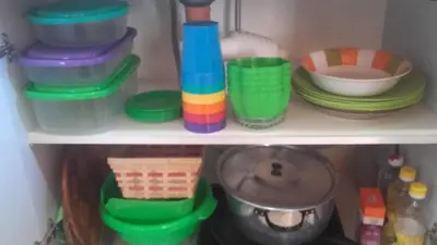 a shelf with colorful bowls and plates on it at Cabañas Jazmines del Lago in San Roque