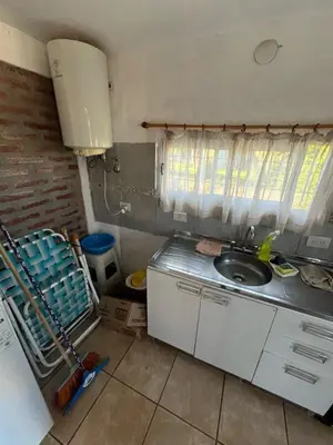 a small kitchen with a sink and a window at Cabañas Jazmines del Lago in San Roque