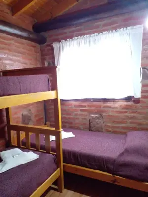 a bedroom with a bunk bed and a window at Complejo Don Emilio in Los Reartes