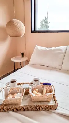 a tray with bread and baskets on a bed at Chañares Complejo de Montaña - Solo Familias y Parejas in Villa Carlos Paz