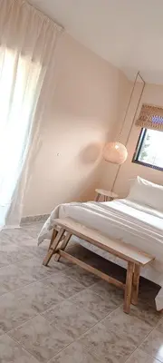 a white bedroom with a bed and a window at Chañares Complejo de Montaña - Solo Familias y Parejas in Villa Carlos Paz
