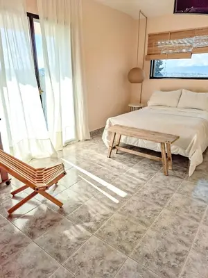 a bedroom with a bed and a chair at Chañares Complejo de Montaña - Solo Familias y Parejas in Villa Carlos Paz