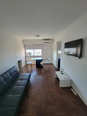 a living room with a couch and a table at departamento centro zona tribunales cordoba in Cordoba