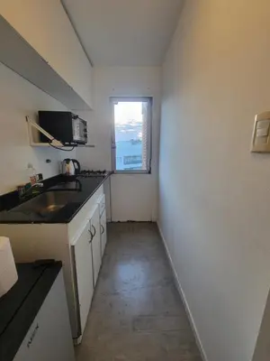 a small kitchen with a sink and a window at departamento centro zona tribunales cordoba in Cordoba