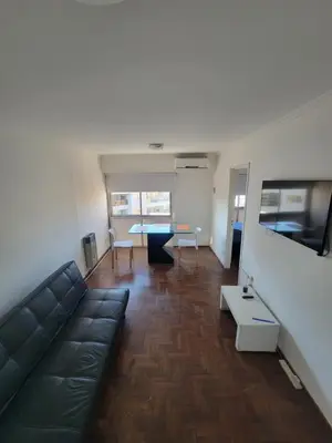 a living room with a couch and a table at departamento centro zona tribunales cordoba in Cordoba
