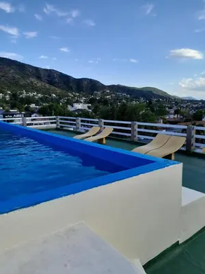 a swimming pool on the roof of a house at Departamento Anita Villa Carlos Paz in Villa Carlos Paz