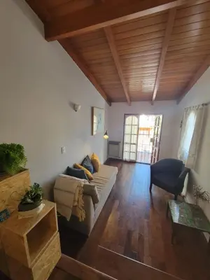 a living room with a couch and a table at Cálido departamento, cerca de la universidad y de importantes hospitales in Cordoba