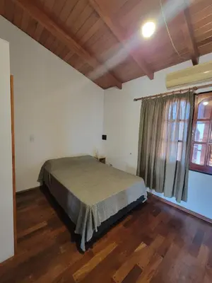 a bedroom with a bed and a large window at Cálido departamento, cerca de la universidad y de importantes hospitales in Cordoba
