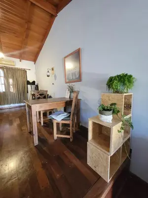 a dining room with a wooden table and chairs at Cálido departamento, cerca de la universidad y de importantes hospitales in Cordoba