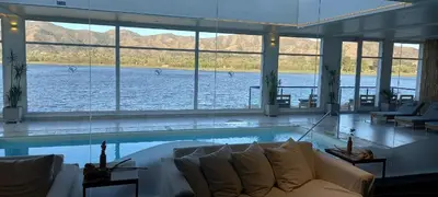 a living room with a pool of water with a couch at Veneto Village in Villa Parque Siquiman