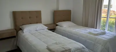 two beds in a room with a window at Veneto Village in Villa Parque Siquiman