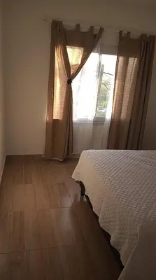 a bedroom with a bed and a window at EL Mirador Soñado in Villa Carlos Paz