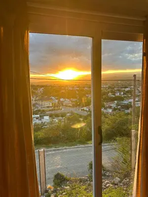 a view of a sunset from a window at EL Mirador Soñado in Villa Carlos Paz