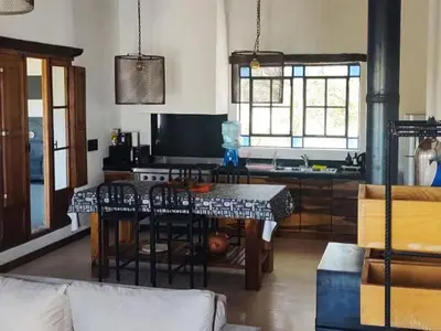 a living room with a table and a kitchen at Cabañas San Javier in Pueblito